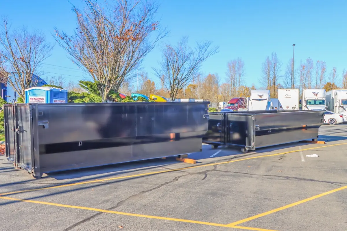 Professional dumpster rental service with roll-off container on residential driveway in Red Hook